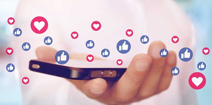Man with phone showing showing media icons
